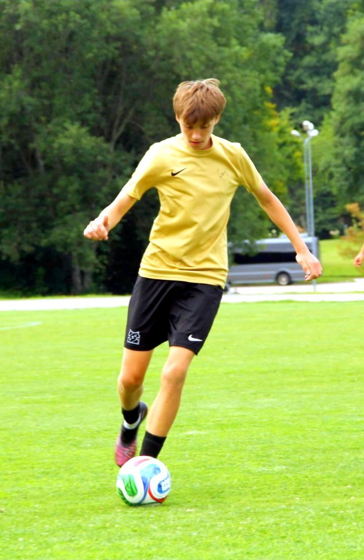 Aleksandr Dauber on the ball in the gold Jūrmala FS kit
