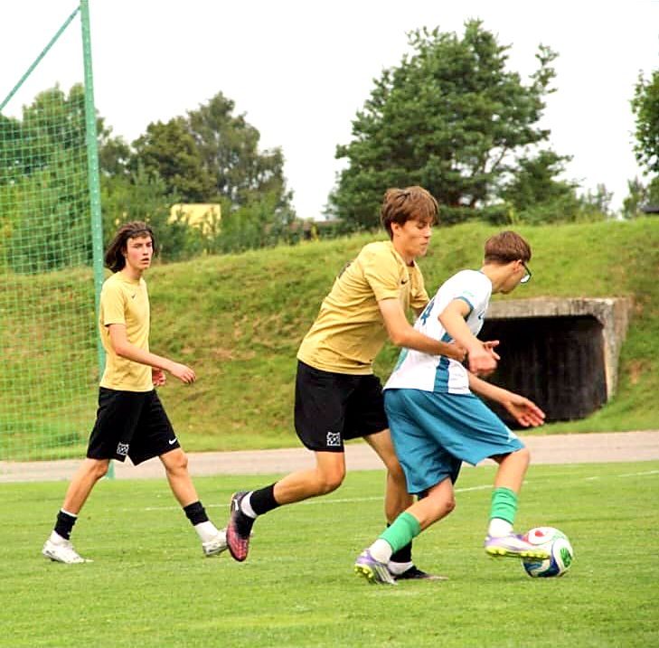 Aleksandr Dauber challenging an opponent for the ball